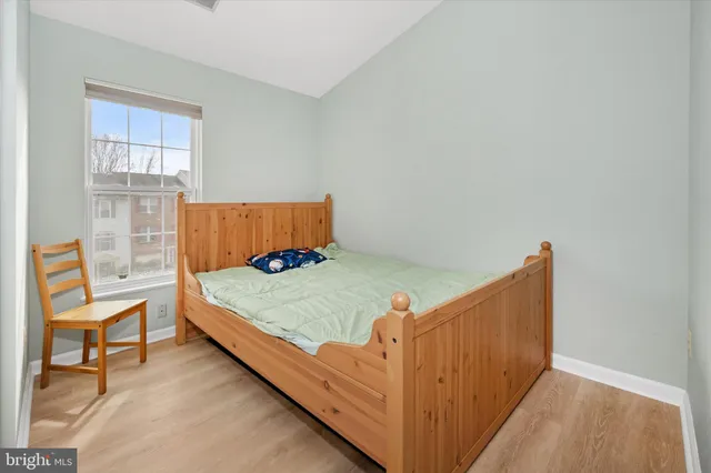 a bed sitting in a bedroom next to a window