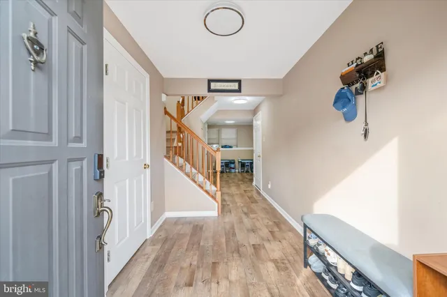 a view of a livingroom with wooden floor and stairs