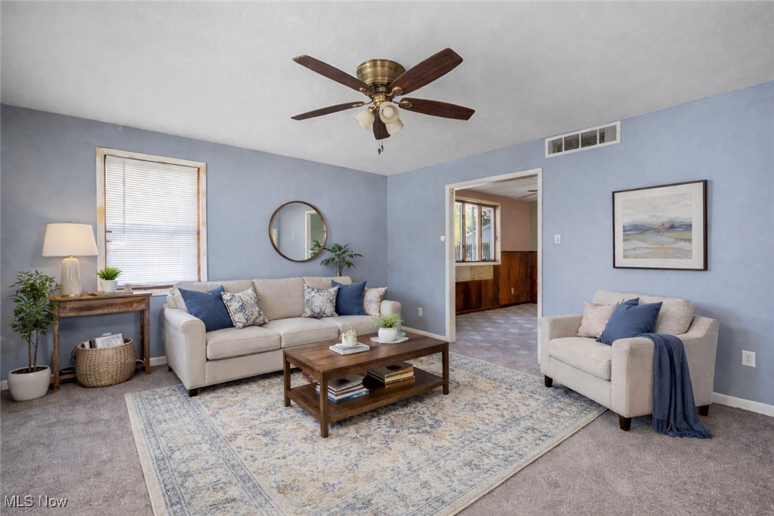 6927 North Wildacre Road Curtice, OH 43412 - Photo 5 of 44 Carpeted living area featuring a ceiling fan
