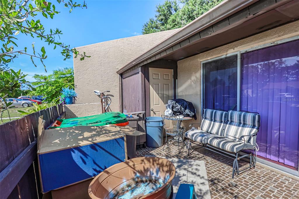 10039 88th Street Seminole, FL 33777 - Photo 36 of 44 a backyard of a house with barbeque oven table and chairs