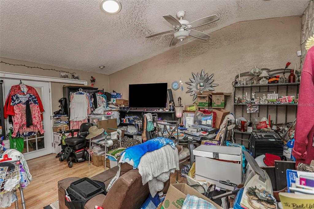 10039 88th Street Seminole, FL 33777 - Photo 7 of 44 a living room with lots of furniture and a flat screen tv