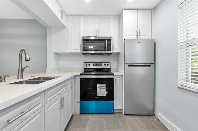 a kitchen with a refrigerator sink and stove