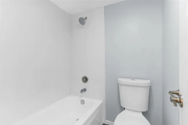 a white toilet sitting next to a bathroom sink