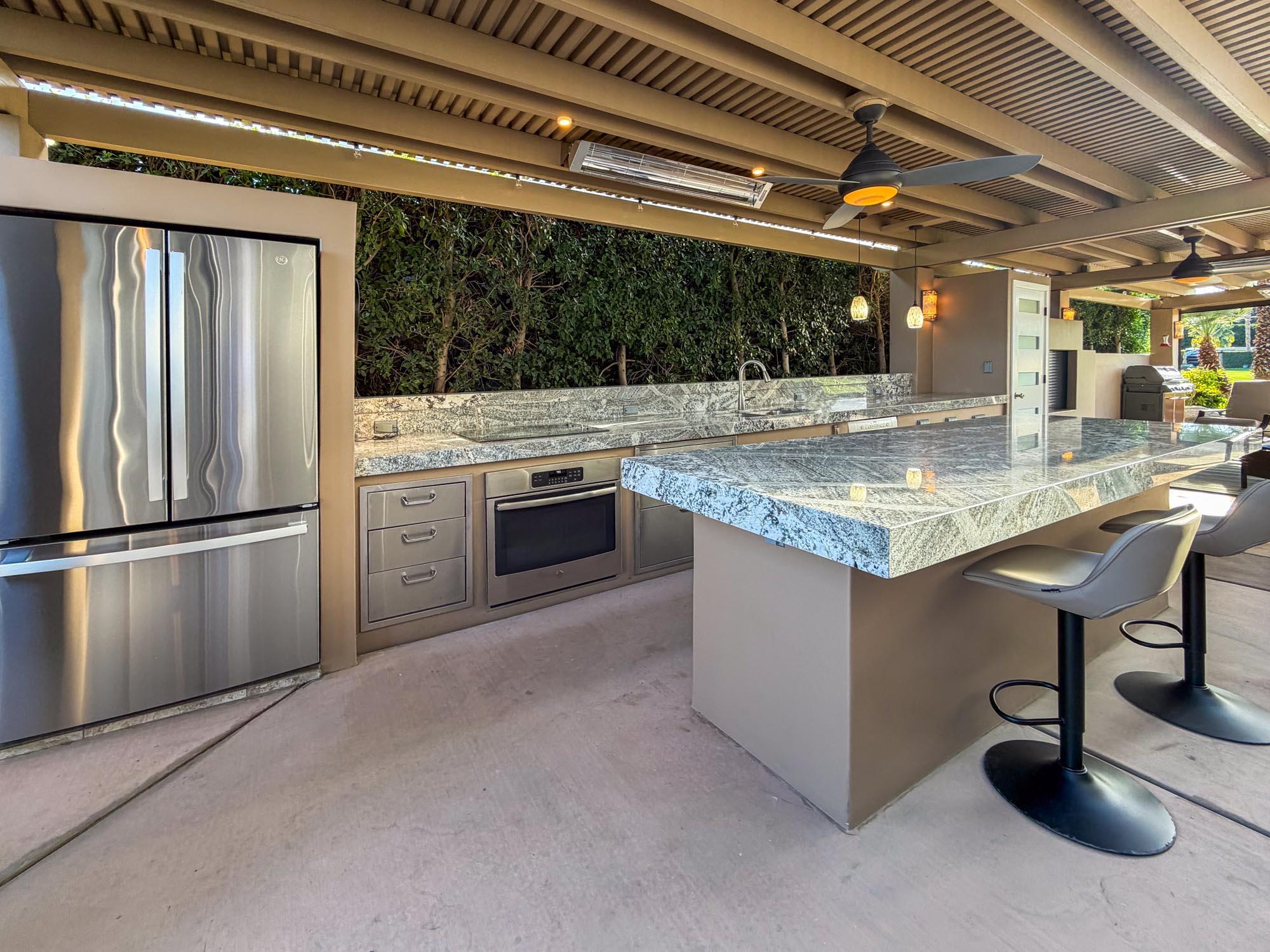 80394 Ave 48, Unit 298 Indio, CA 92201 - Photo 2 of 25 a kitchen with stainless steel appliances granite countertop a sink and a refrigerator