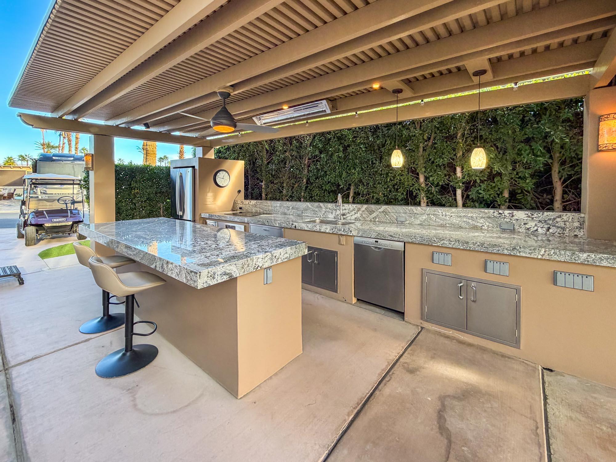 80394 Ave 48, Unit 298 Indio, CA 92201 - Photo 21 of 25 a kitchen with sink cabinets and outdoor view