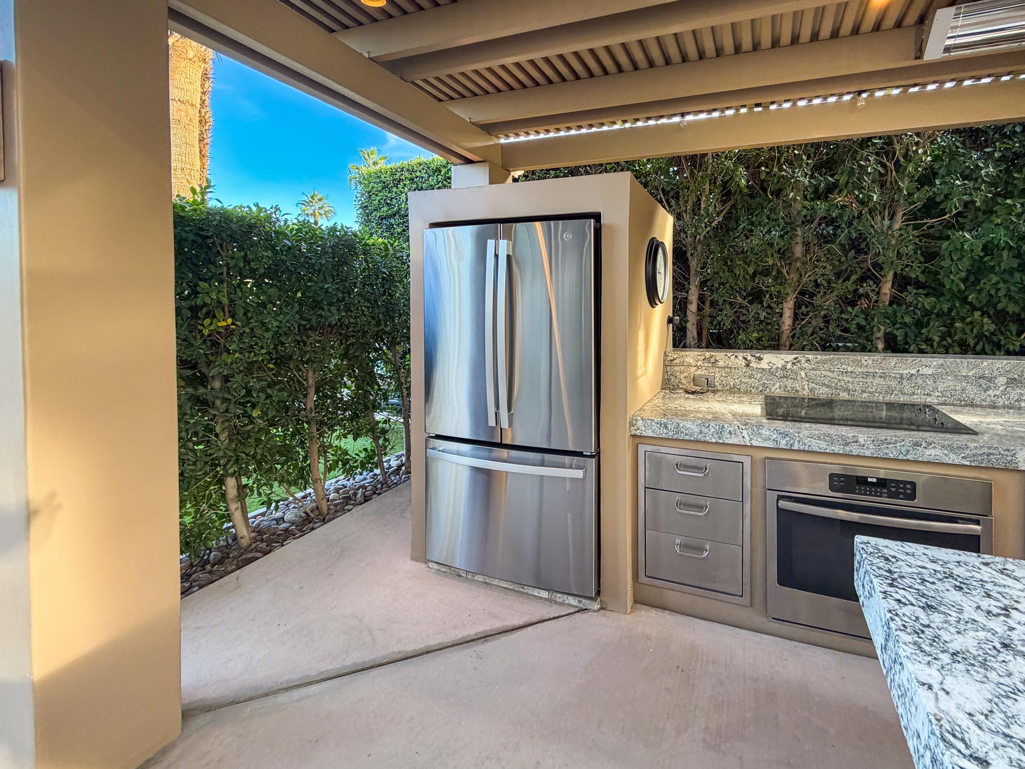 80394 Ave 48, Unit 298 Indio, CA 92201 - Photo 23 of 25 a kitchen with stainless steel appliances granite countertop a refrigerator and a sink