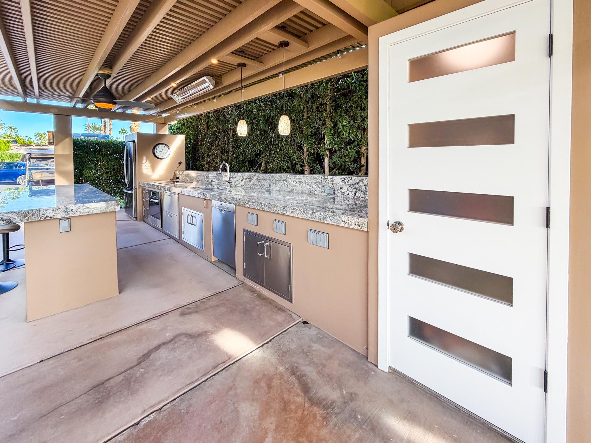 80394 Ave 48, Unit 298 Indio, CA 92201 - Photo 5 of 25 a view of a kitchen with stainless steel appliances kitchen island granite countertop a sink and a cabinets