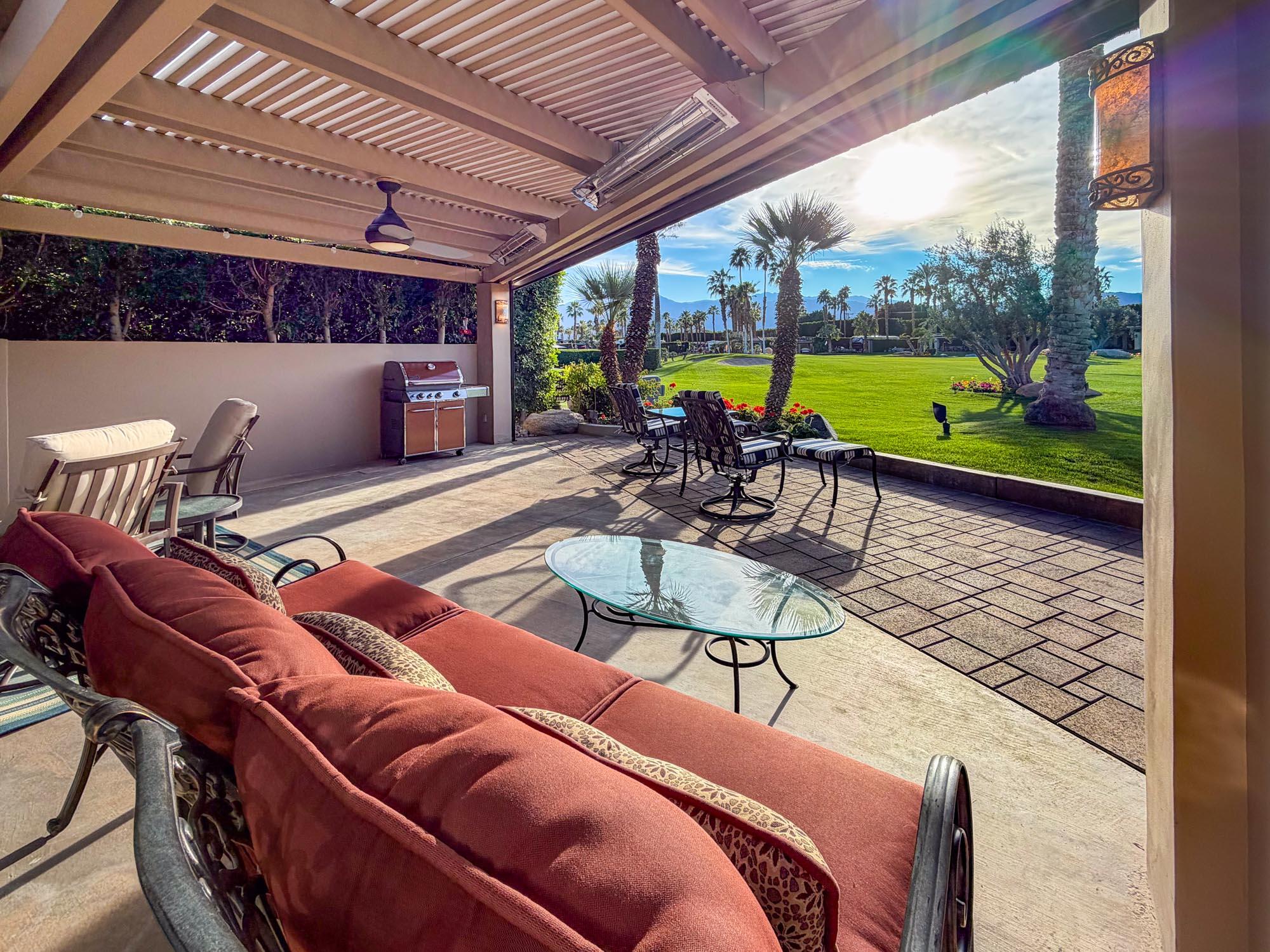 80394 Ave 48, Unit 298 Indio, CA 92201 - Photo 9 of 25 a view of a patio with a table chairs and a backyard