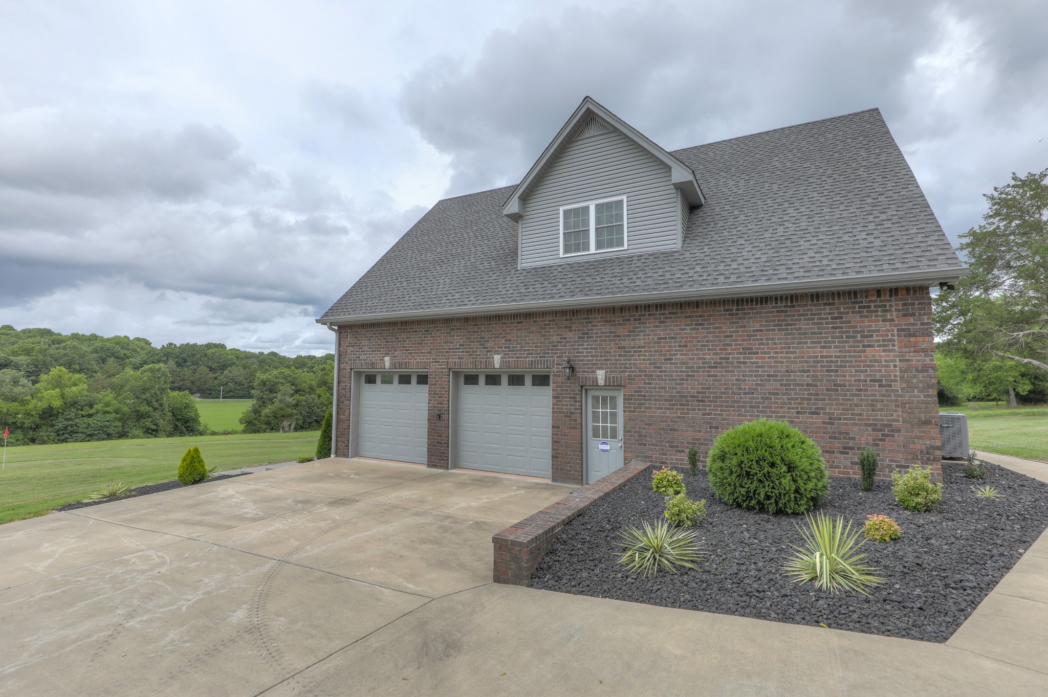 465 North Commerce Road Watertown, TN 37184 - Photo 27 of 47 a front view of a house with a yard and garage