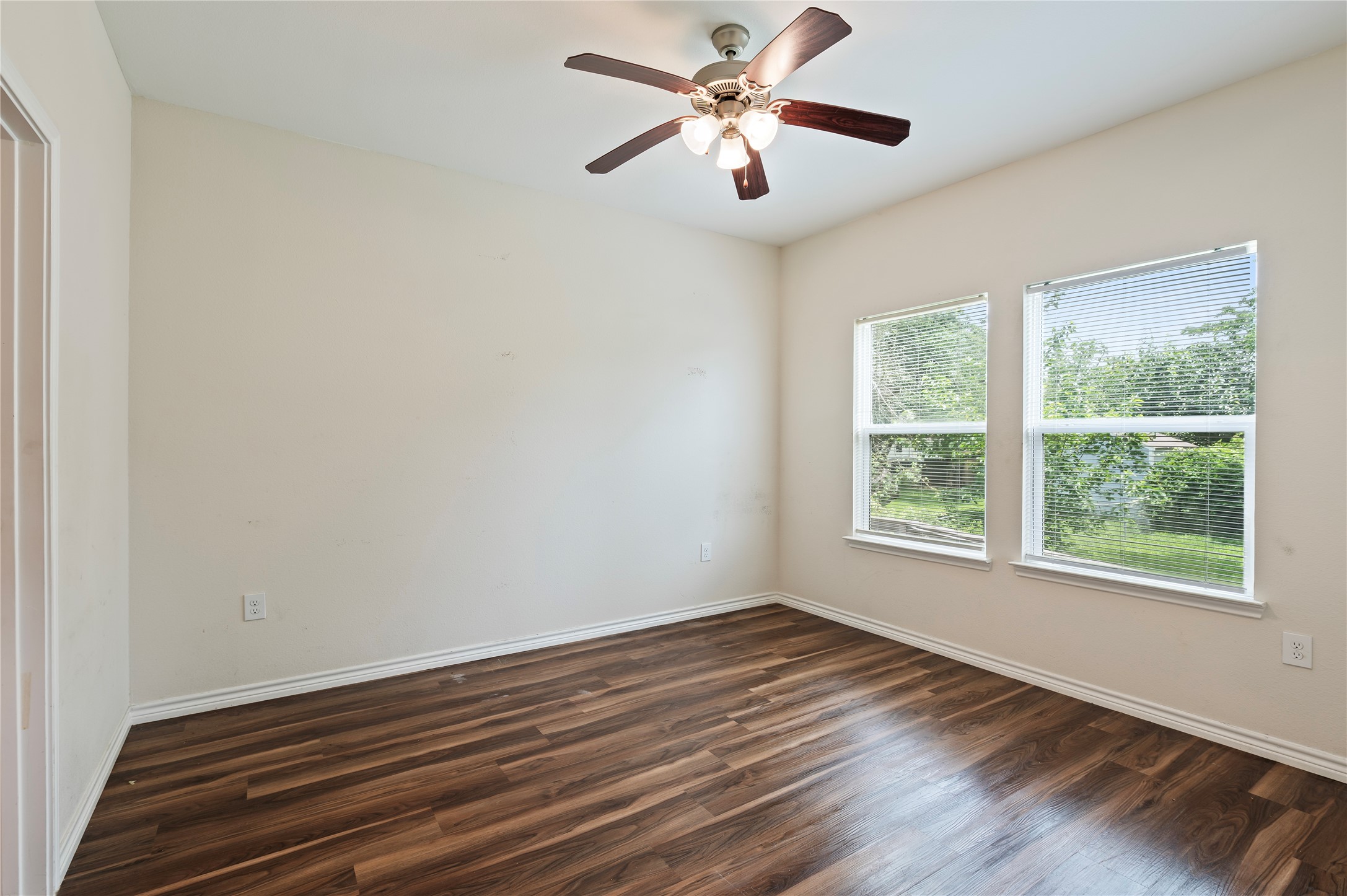 1125 Lake Road La Marque, TX 77568 - Photo 18 of 33 a view of an empty room with wooden floor and a window