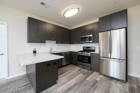 a kitchen with a refrigerator stove and wooden cabinets
