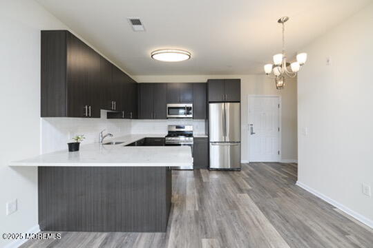 2 Henessey Boulevard, Unit 304 Atlantic Highlands, NJ 07716 - Photo 5 of 19 a kitchen with kitchen island a sink stainless steel appliances and cabinets