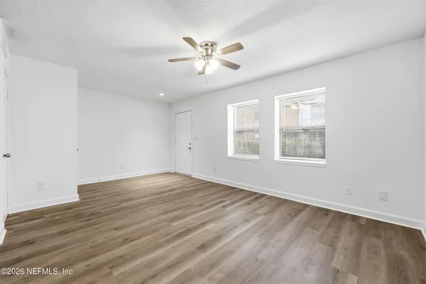 wooden floor in an empty room with a window