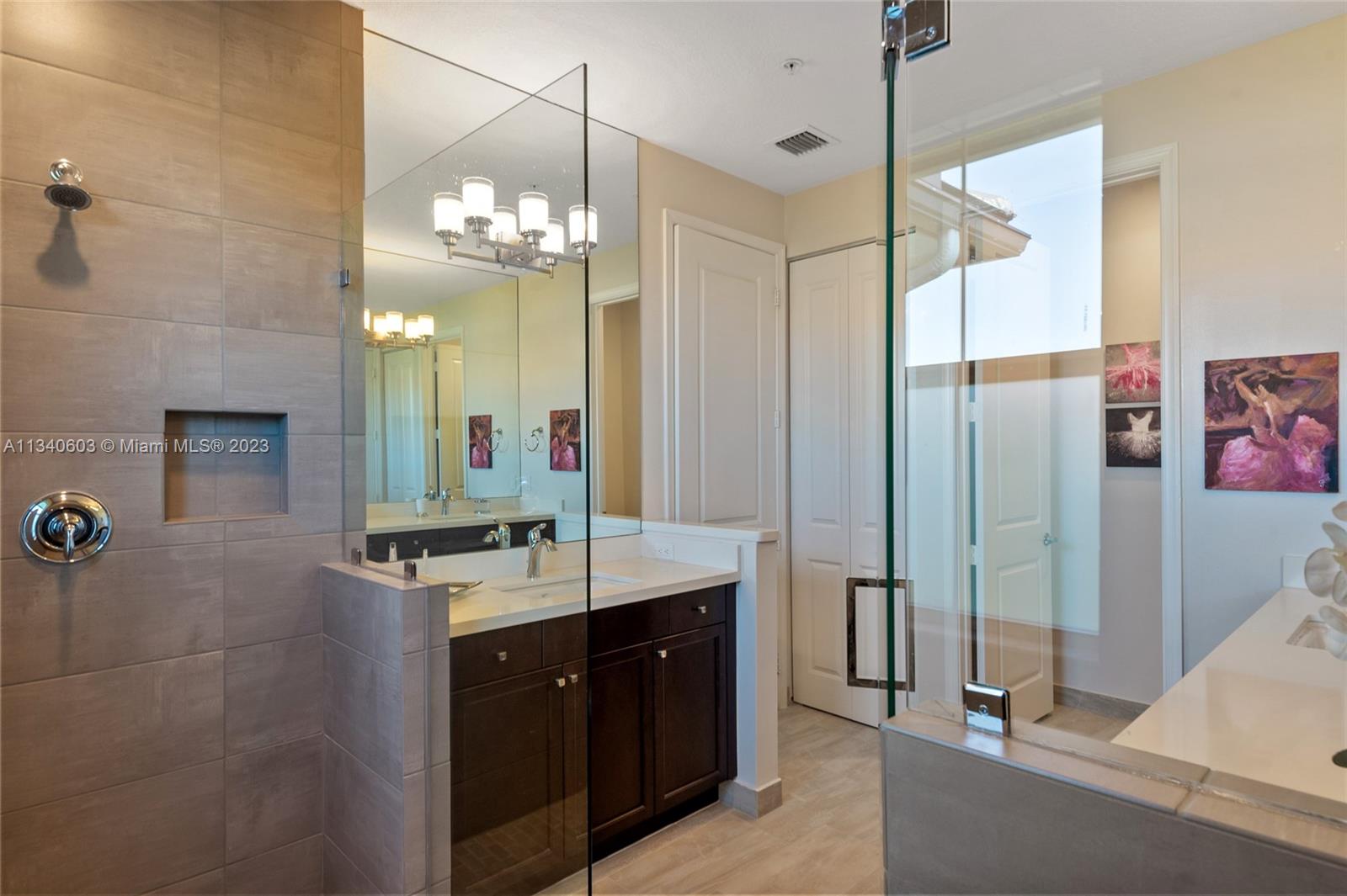 22936 Clear Echo Drive, Unit 34 Boca Raton, FL 33433 - Photo 22 of 41 a bathroom with a double vanity sink mirror and shower