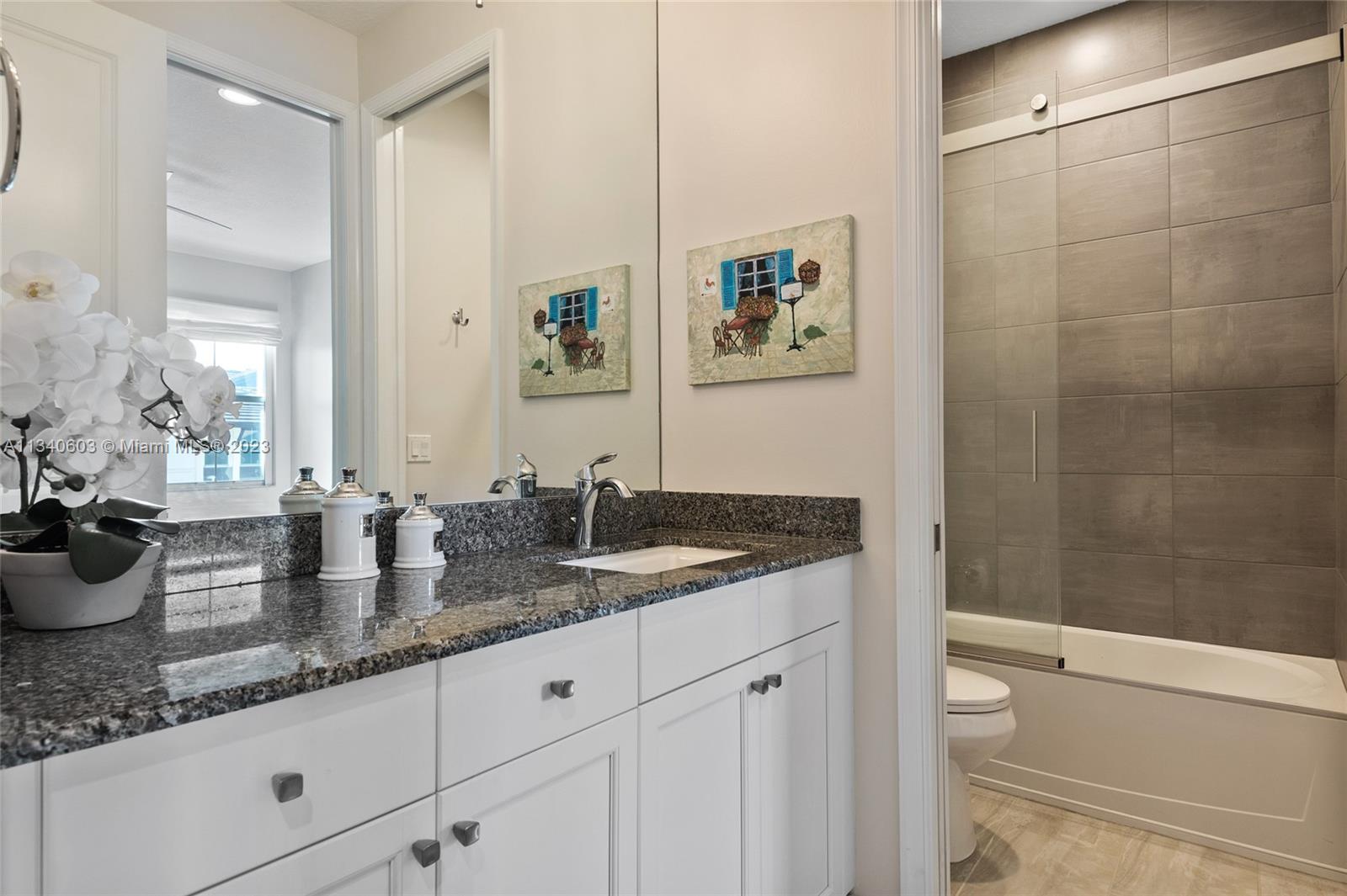 22936 Clear Echo Drive, Unit 34 Boca Raton, FL 33433 - Photo 29 of 41 a bathroom with sink and mirror