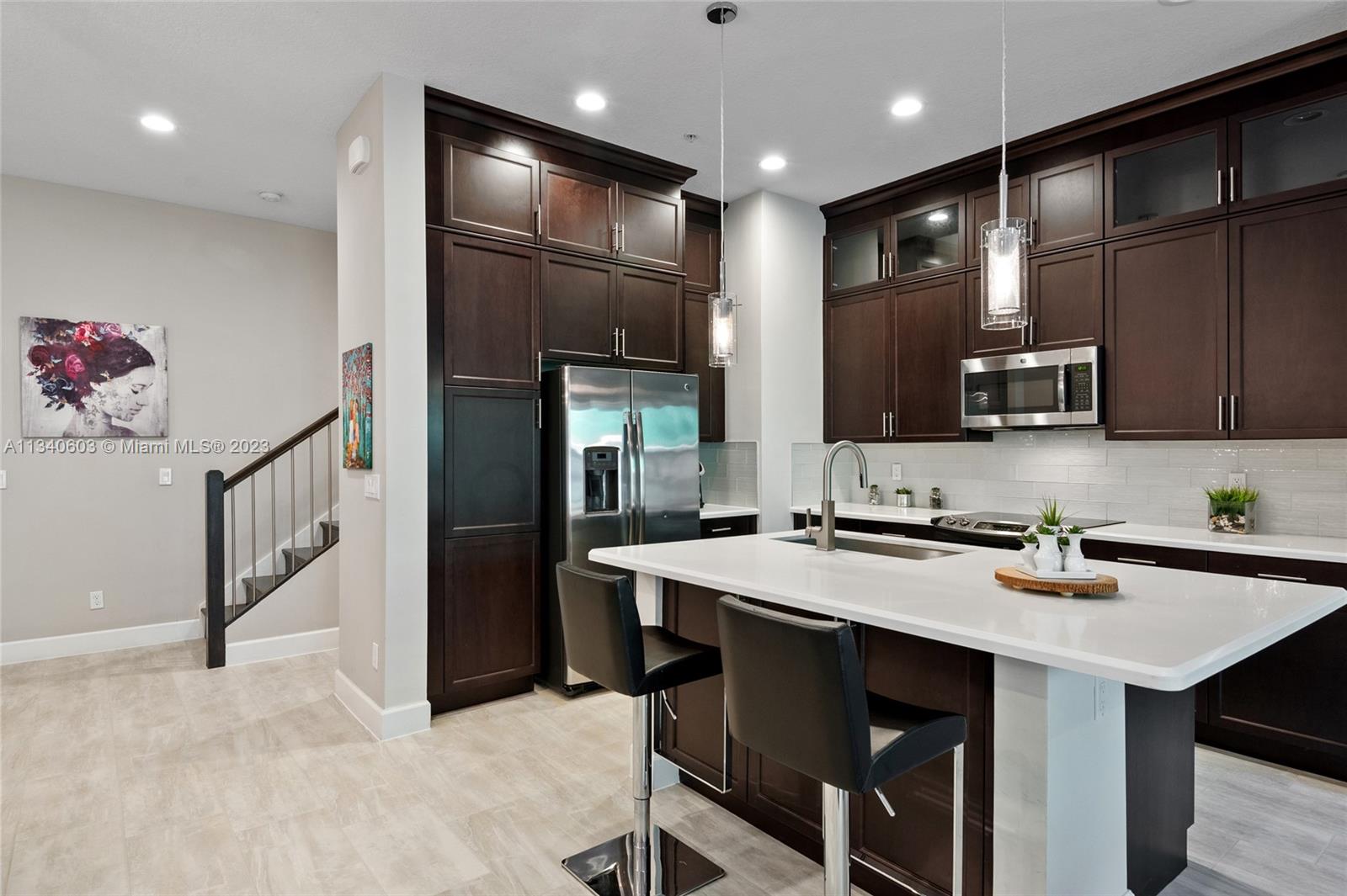 22936 Clear Echo Drive, Unit 34 Boca Raton, FL 33433 - Photo 3 of 41 a kitchen with stainless steel appliances a microwave sink refrigerator and cabinets