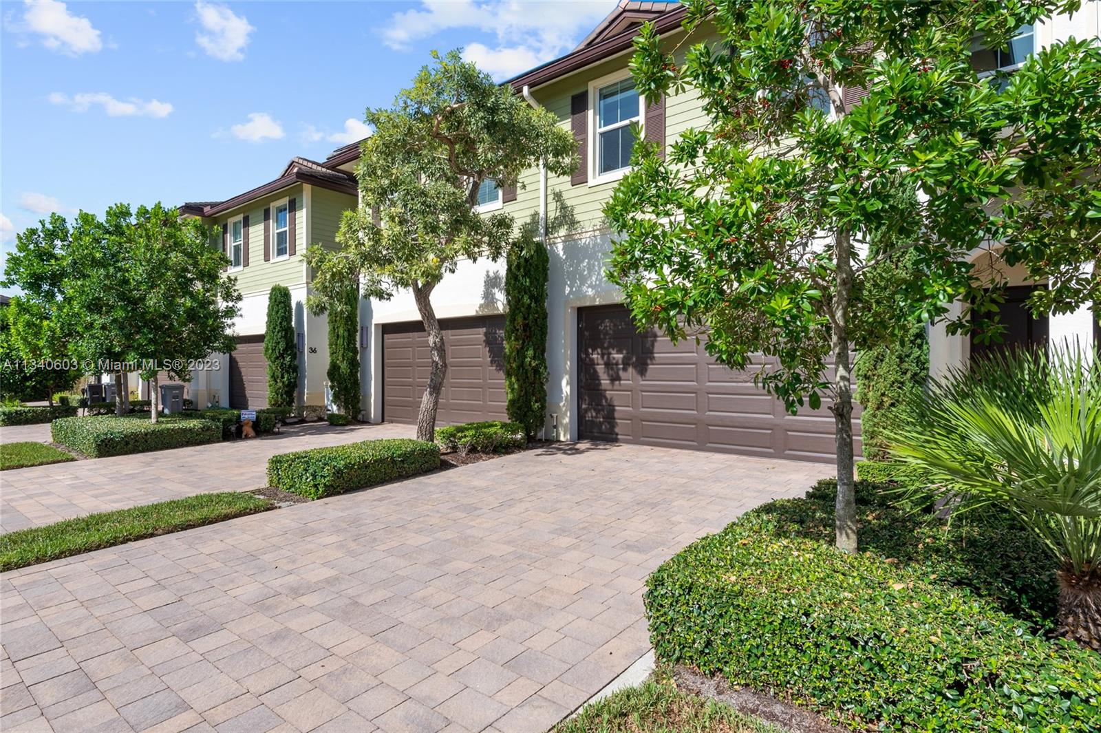 22936 Clear Echo Drive, Unit 34 Boca Raton, FL 33433 - Photo 32 of 41 a front view of a house with a yard and a garage