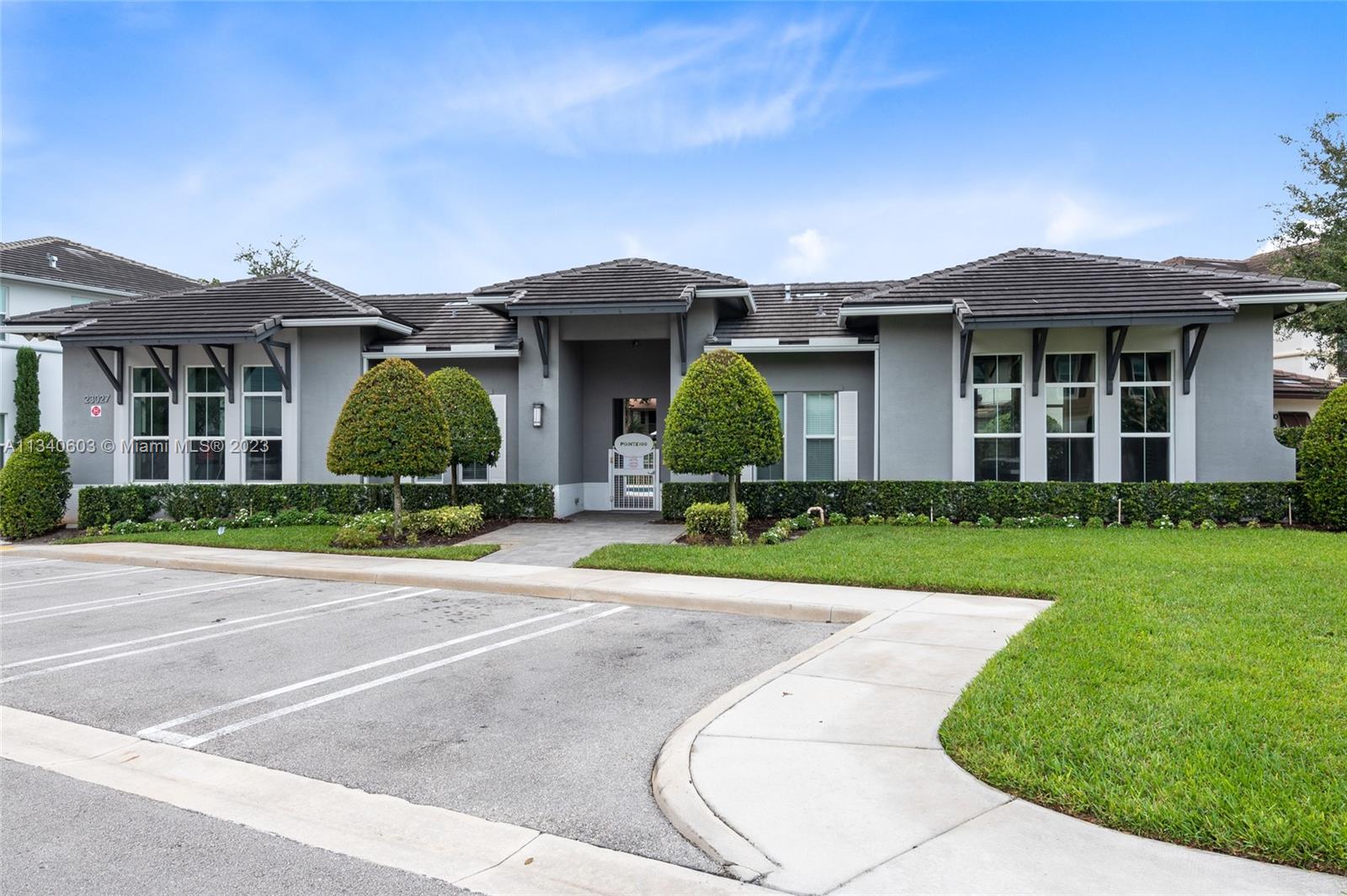 22936 Clear Echo Drive, Unit 34 Boca Raton, FL 33433 - Photo 38 of 41 front view of a brick house with a yard