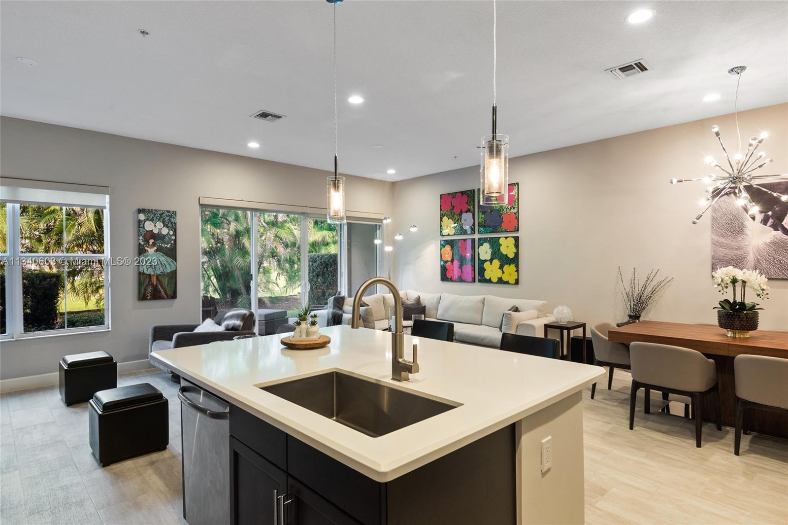 22936 Clear Echo Drive, Unit 34 Boca Raton, FL 33433 - Photo 5 of 41 a kitchen with a sink a counter top space and living room view
