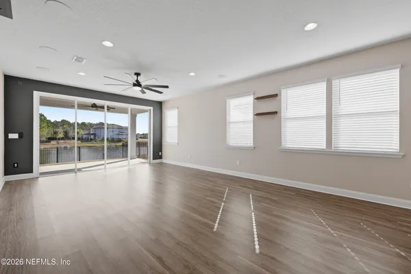 a bathroom with a sink a toilet a mirror and a window