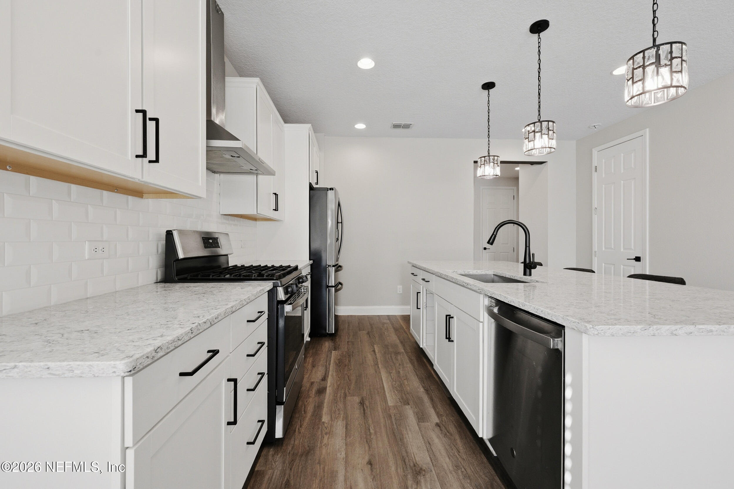 214 Pepperpike Way St. Augustine, FL 32092 - Photo 26 of 63 a kitchen with stainless steel appliances granite countertop a sink a stove and a refrigerator