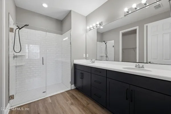 a view of a yard with flower plants and wooden fence