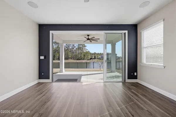 wooden floor in an empty room with a window