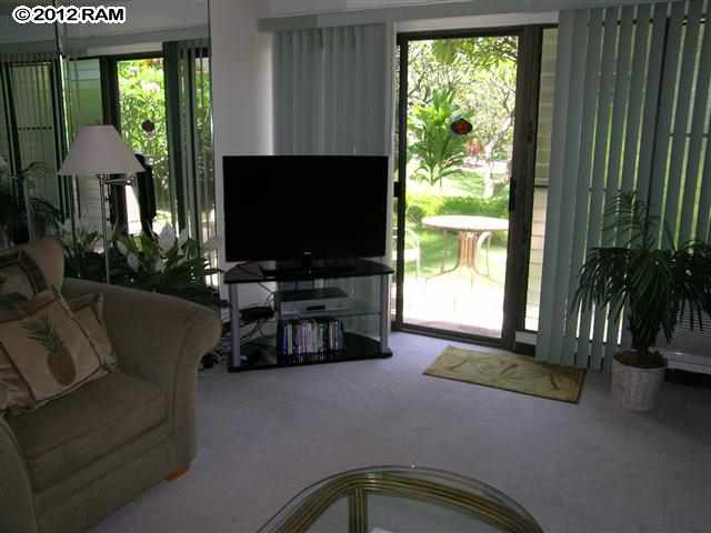 2531 South Kihei Road, Unit C211 Kihei, HI 96753 - Photo 2 of 12 a living room with furniture and a flat screen tv