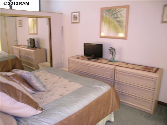 2531 South Kihei Road, Unit C211 Kihei, HI 96753 - Photo 8 of 12 a bedroom with a bed and a flat screen tv
