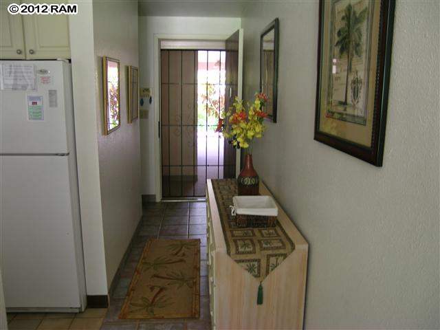 2531 South Kihei Road, Unit C211 Kihei, HI 96753 - Photo 10 of 12 a hallway with wooden floor and windows
