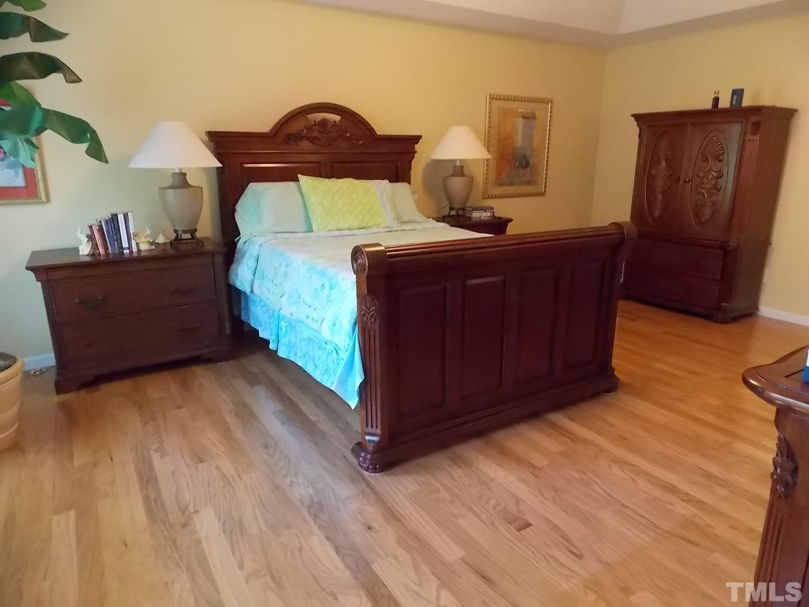 4224 White Chapel Way Raleigh, NC 27615 - Photo 22 of 30 a bedroom with a bed and wooden floor