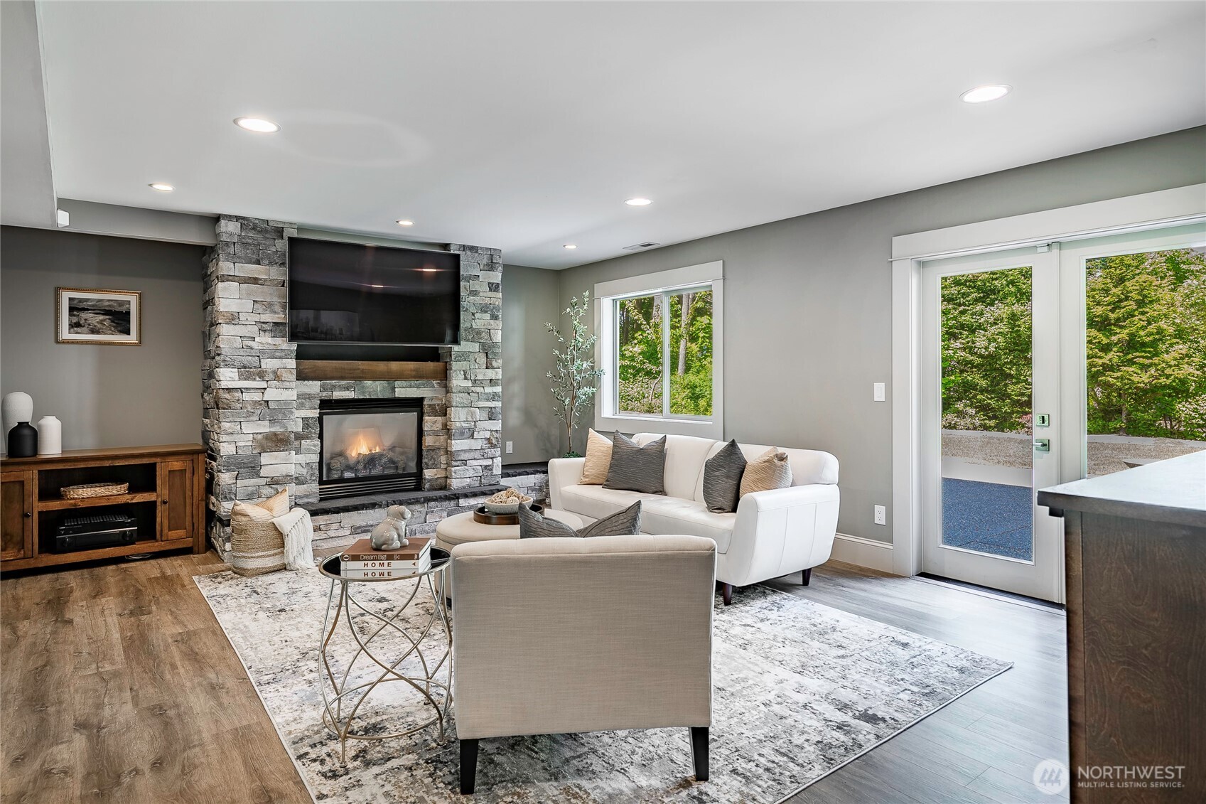 9125 Shearwater Road Blaine, WA 98230 - Photo 27 of 40 a living room with furniture a fireplace and a flat screen tv