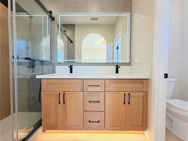 a bathroom with a sink a mirror and vanity