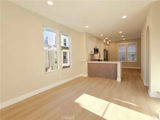 a view of a kitchen with furniture and wooden floor
