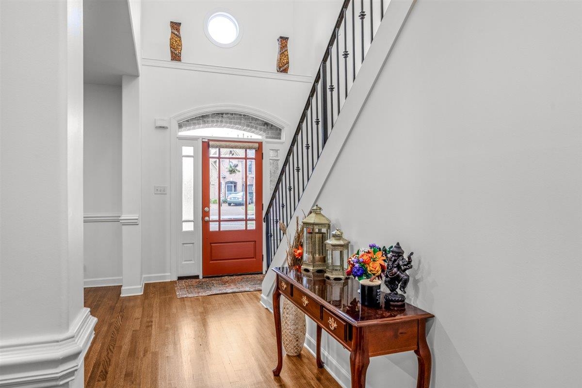 744 Southern Home Road Collierville, TN 38017 - Photo 2 of 24 Entry foyer featuring wood-finish flooring, a red front door with sidelights, an arched transom, and a high ceiling with a circular window