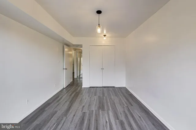 a view of a room with wooden floor fan and window