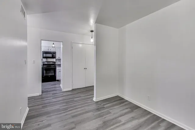 a view of a kitchen with wooden floor and a kitchen