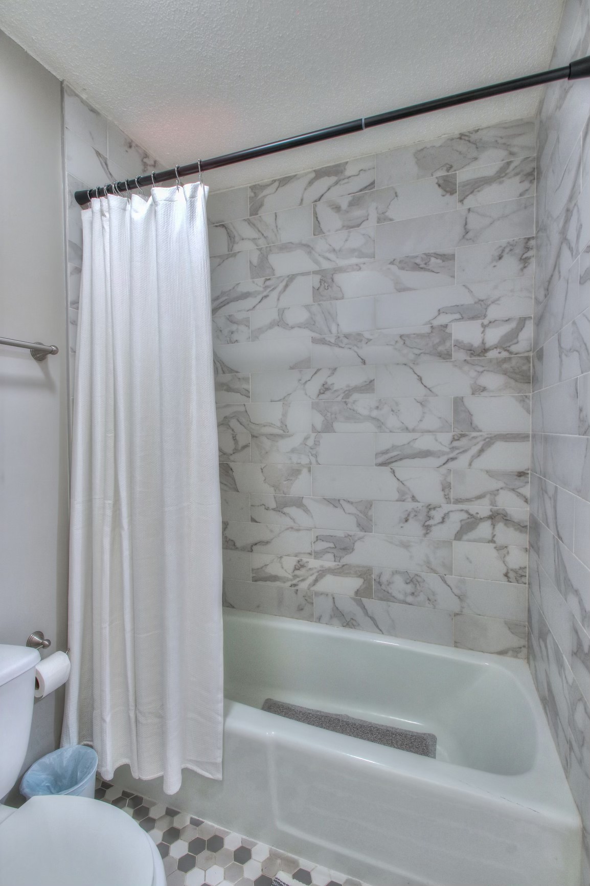 500 Paragon Mills Road, Unit N15 Nashville, TN 37211 - Photo 15 of 20 a bathroom with a shower curtain and a bathtub