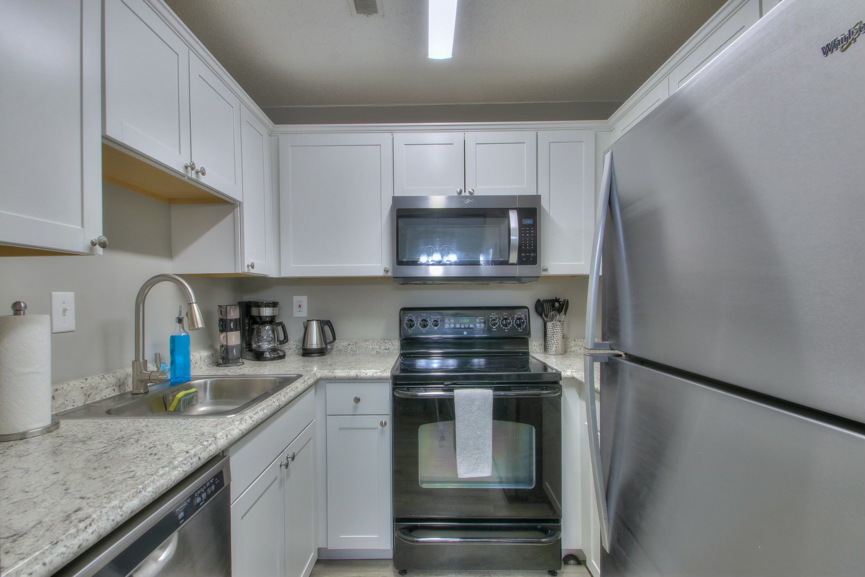 500 Paragon Mills Road, Unit N15 Nashville, TN 37211 - Photo 4 of 20 a kitchen with stainless steel appliances granite countertop a refrigerator sink and stove
