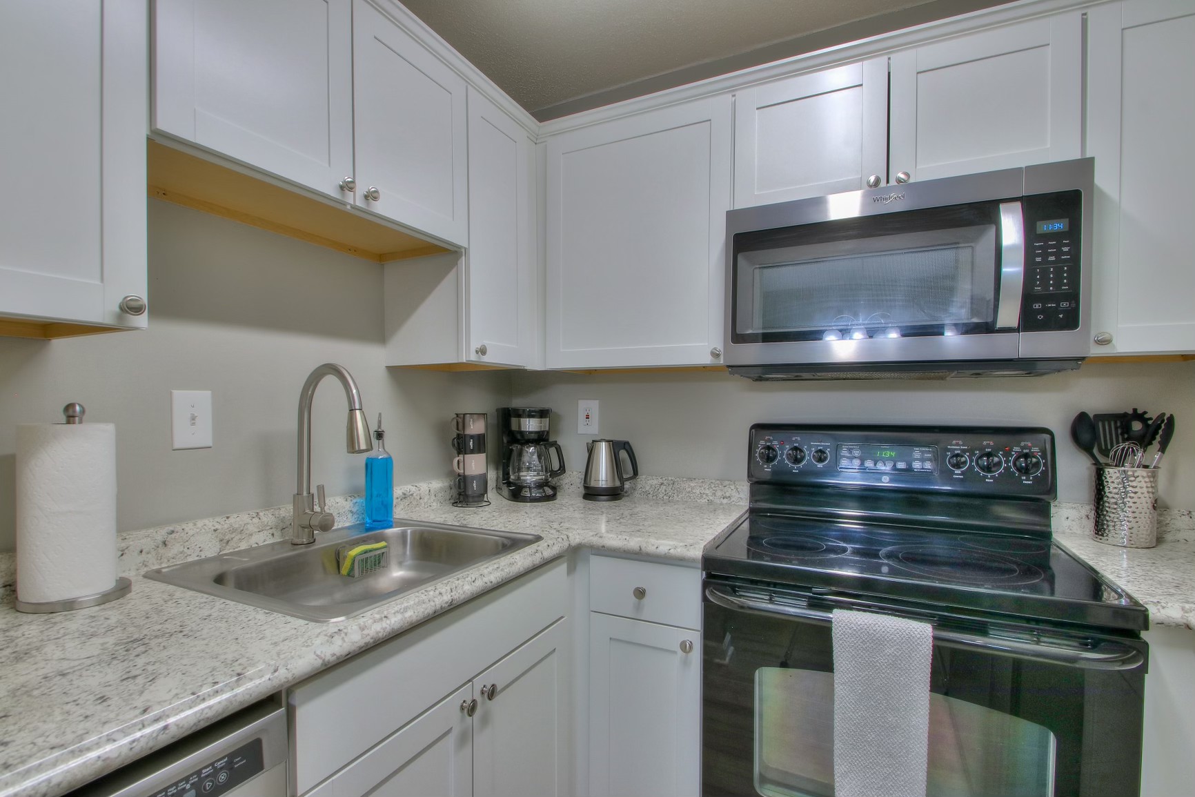 500 Paragon Mills Road, Unit N15 Nashville, TN 37211 - Photo 5 of 20 a kitchen with granite countertop a stove a sink and cabinets