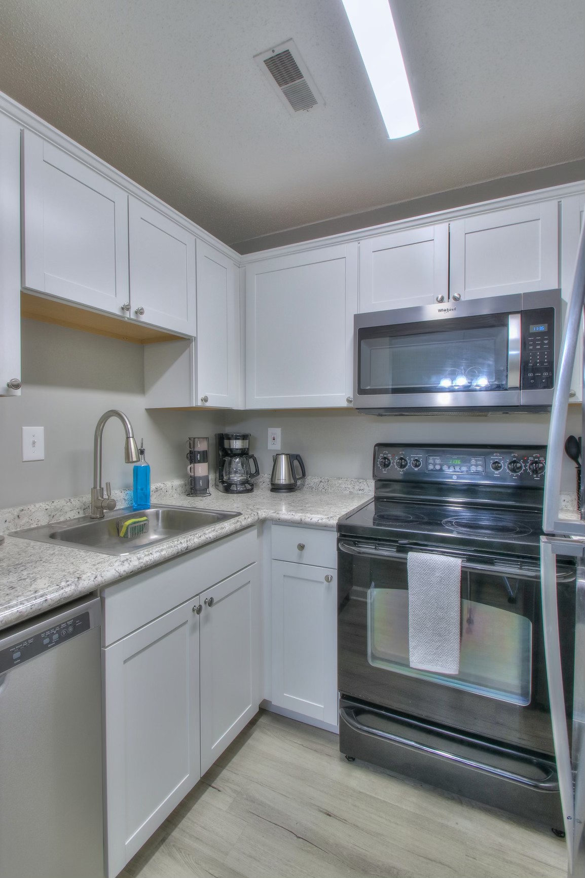 500 Paragon Mills Road, Unit N15 Nashville, TN 37211 - Photo 8 of 20 a kitchen with granite countertop white cabinets and appliances