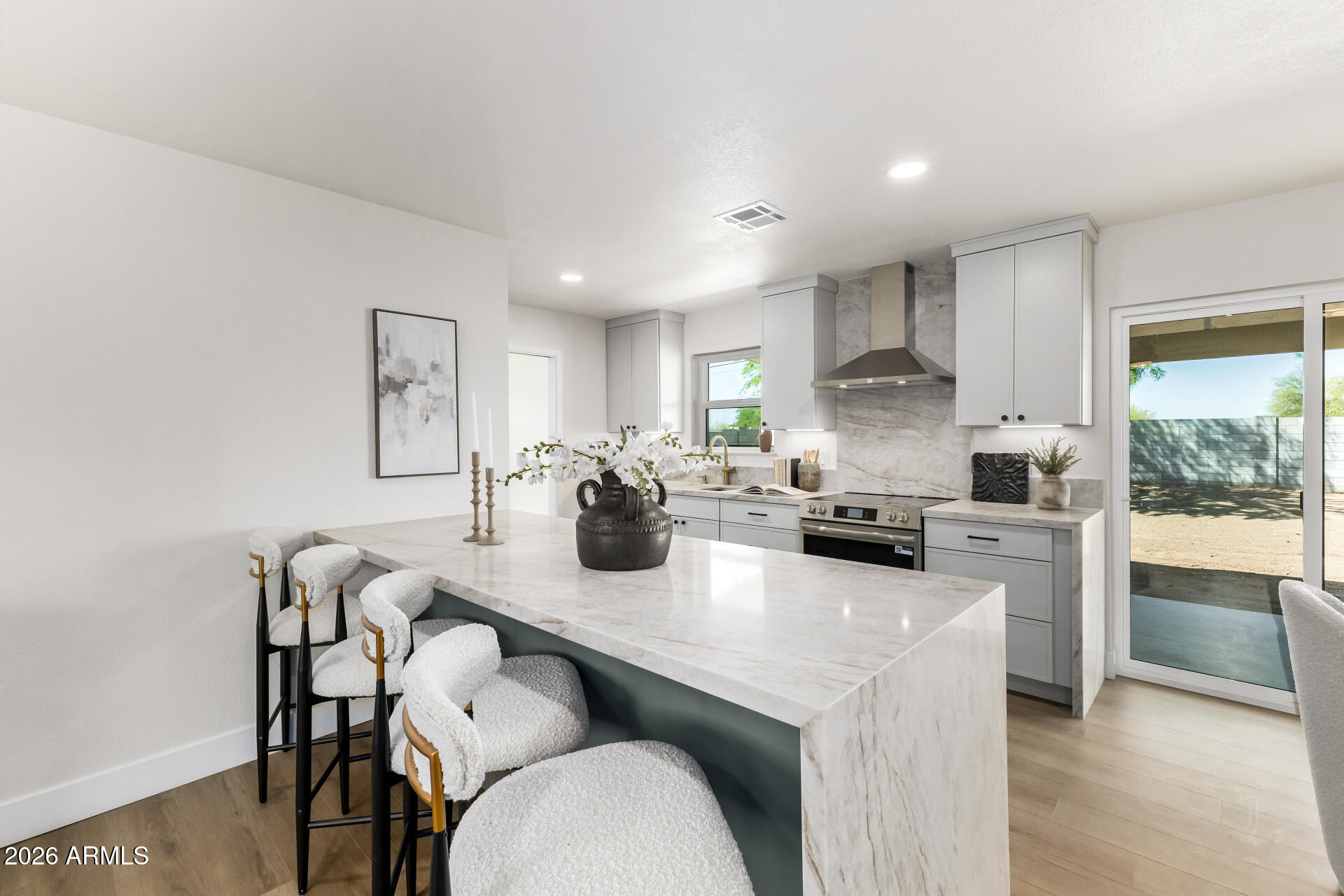 2890 South Mariposa Road Apache Junction, AZ 85119 - Photo 11 of 27 a kitchen with sink a stove and chairs