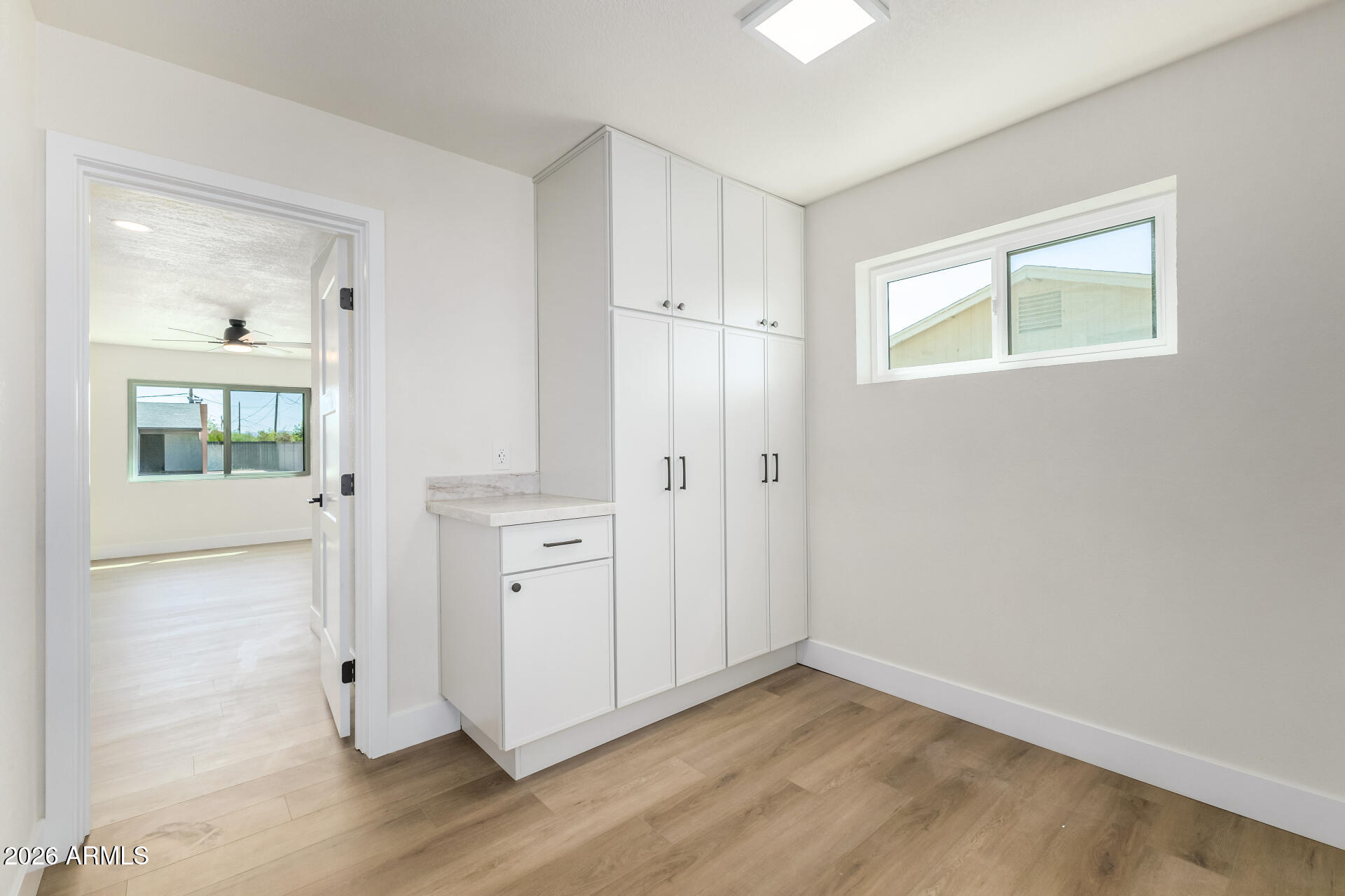 2890 South Mariposa Road Apache Junction, AZ 85119 - Photo 22 of 27 wooden floor in an empty room with a window