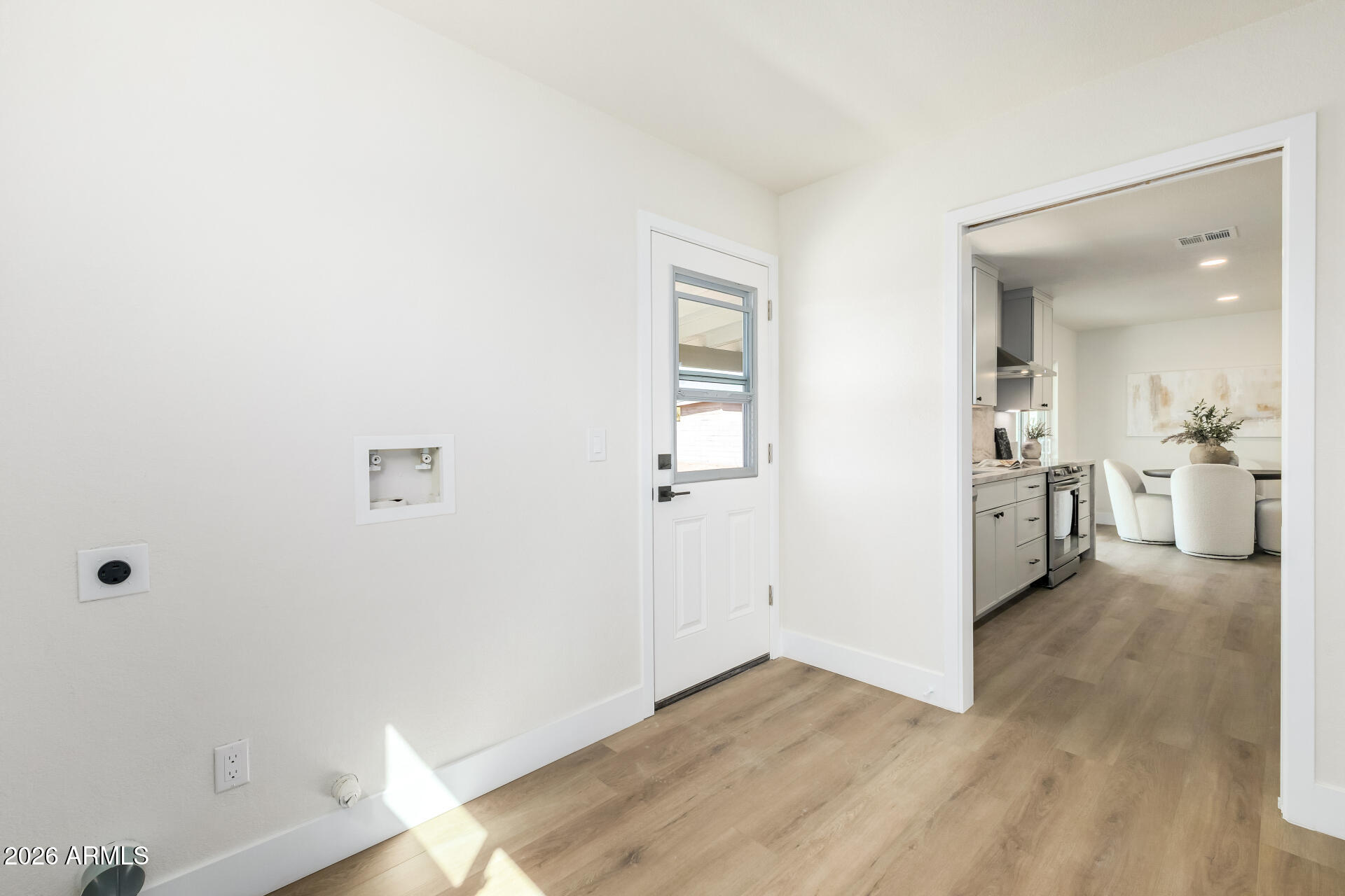 2890 South Mariposa Road Apache Junction, AZ 85119 - Photo 23 of 27 an empty room with wooden floor and white walls