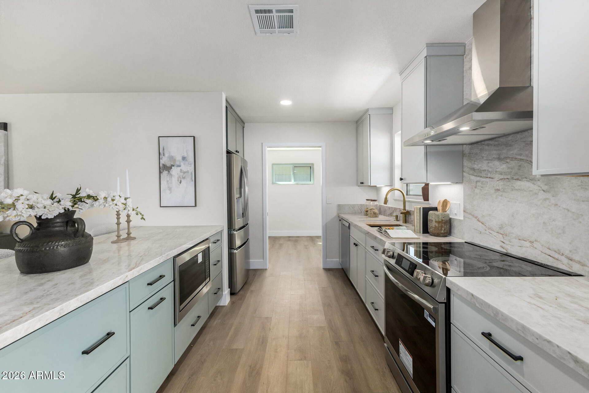 2890 South Mariposa Road Apache Junction, AZ 85119 - Photo 8 of 27 a kitchen with stainless steel appliances a sink stove and cabinets