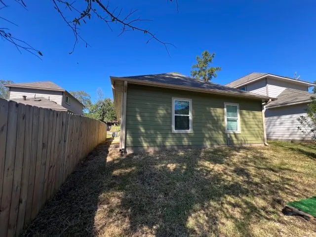 a view of a house with wooden fence