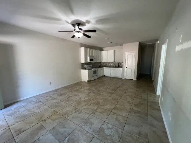 a view of a kitchen with a sink and a refrigerator