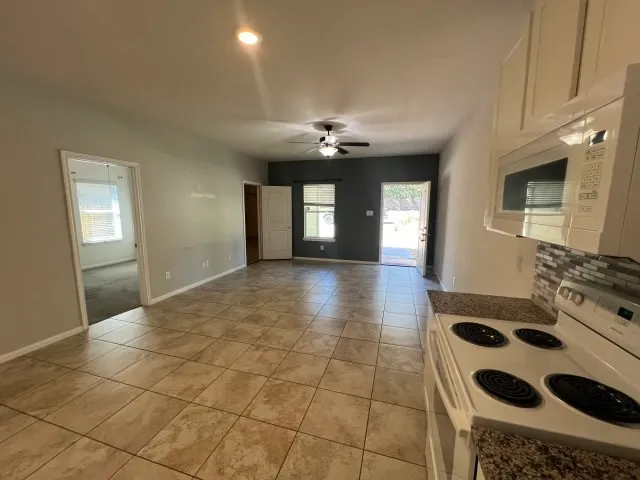 a kitchen with a stove a sink and a microwave