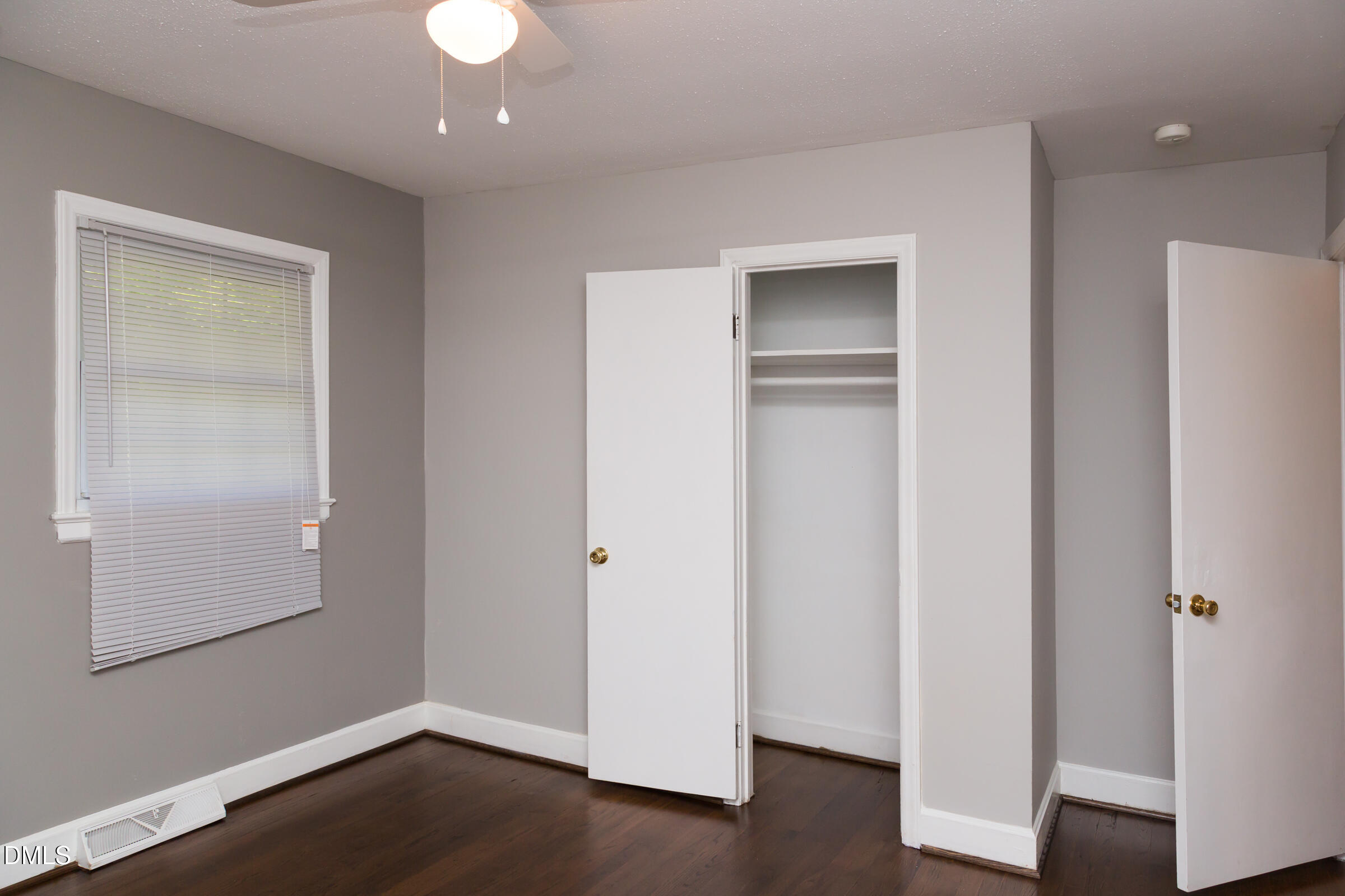 513 North 5th Street Mebane, NC 27302 - Photo 7 of 17 an empty room with wooden floor and closet