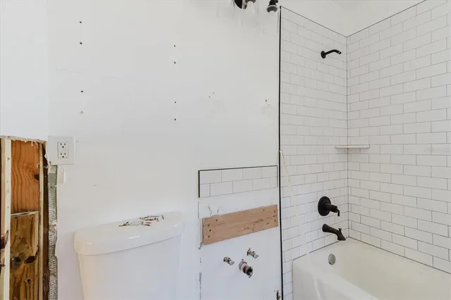 a bathroom with a bathtub and shower